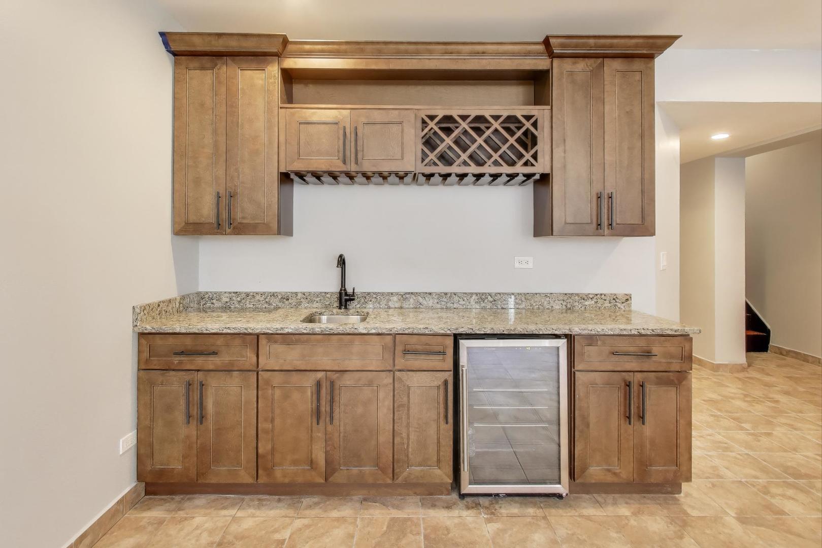 1920 North Springfield Avenue, Unit 1S Chicago, IL 60647 - Photo 26 of 36 a bathroom with a granite countertop sink and a mirror