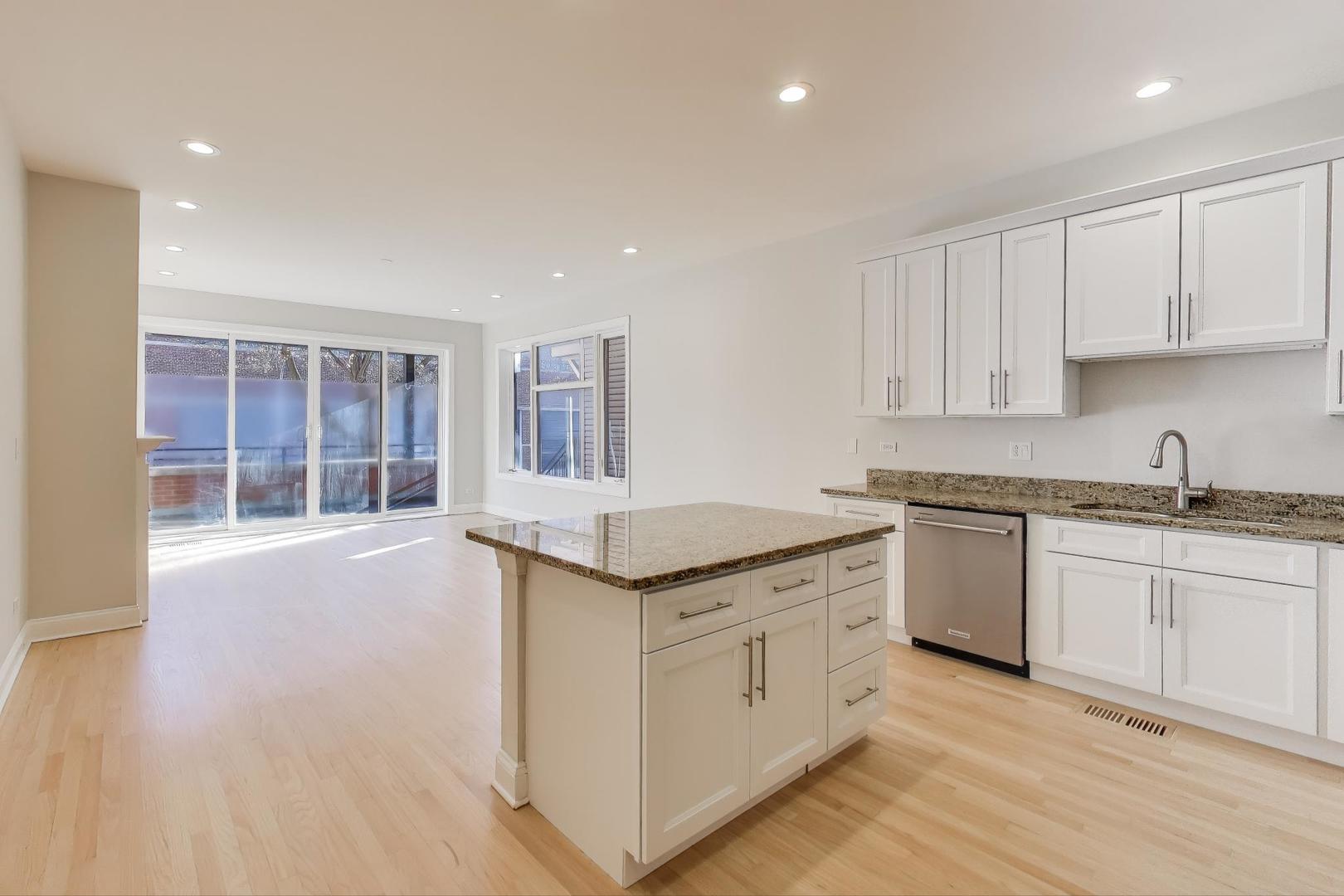 1920 North Springfield Avenue, Unit 1S Chicago, IL 60647 - Photo 6 of 36 a kitchen with granite countertop a sink and cabinets