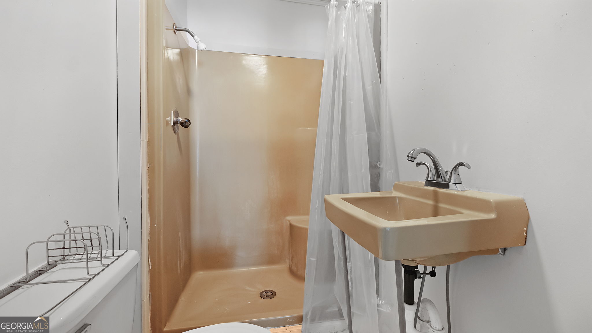 110 Bevis Circle Bowdon, GA 30108 - Photo 20 of 26 a bathroom with a sink a shower and a mirror