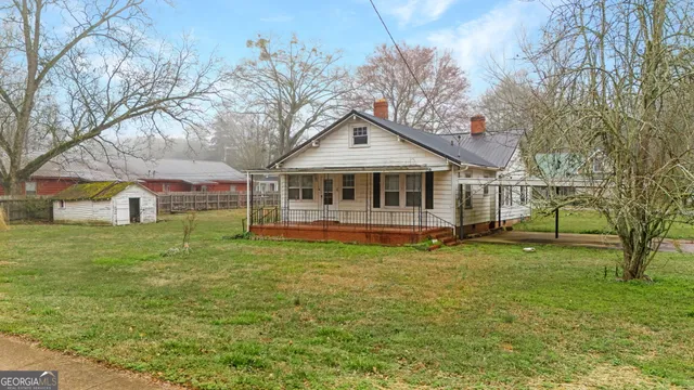 a view of a house with backyard and garden