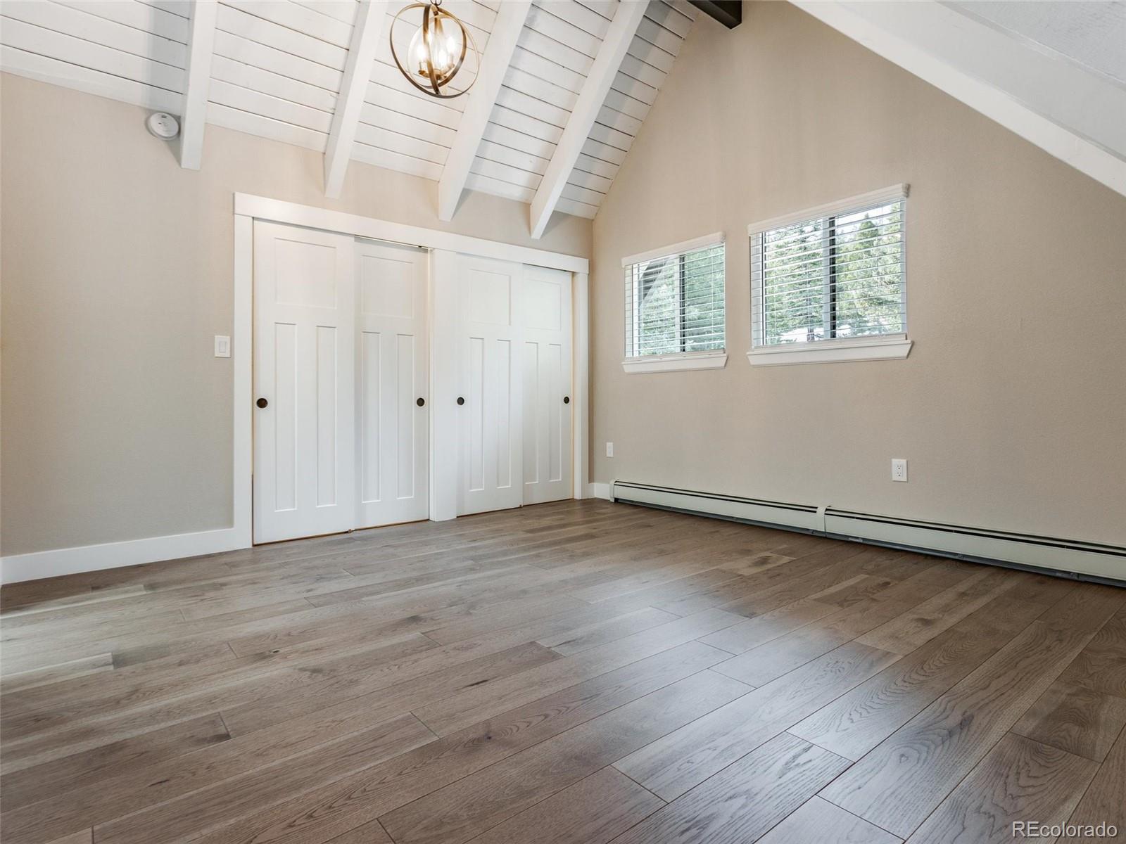 442 Deer Trail Road Boulder, CO 80302 - Photo 15 of 40 a view of an empty room with wooden floor and a window