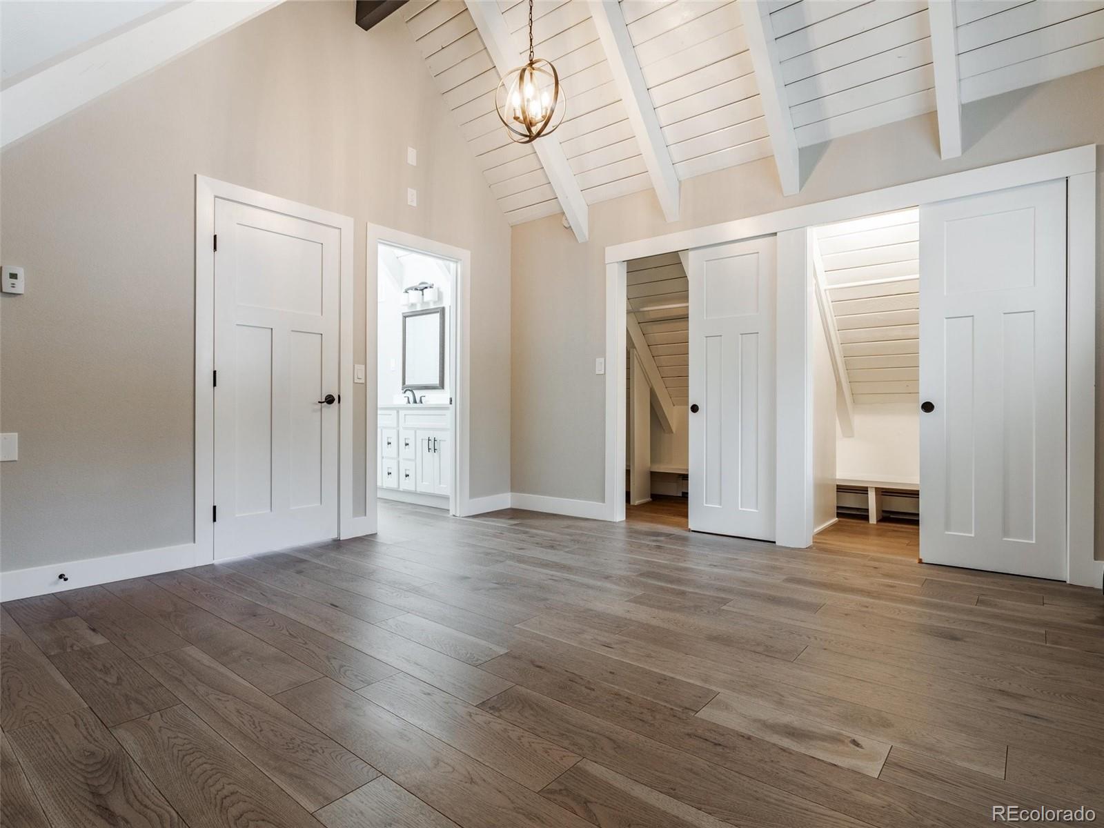 442 Deer Trail Road Boulder, CO 80302 - Photo 16 of 40 an empty room with wooden floor and windows
