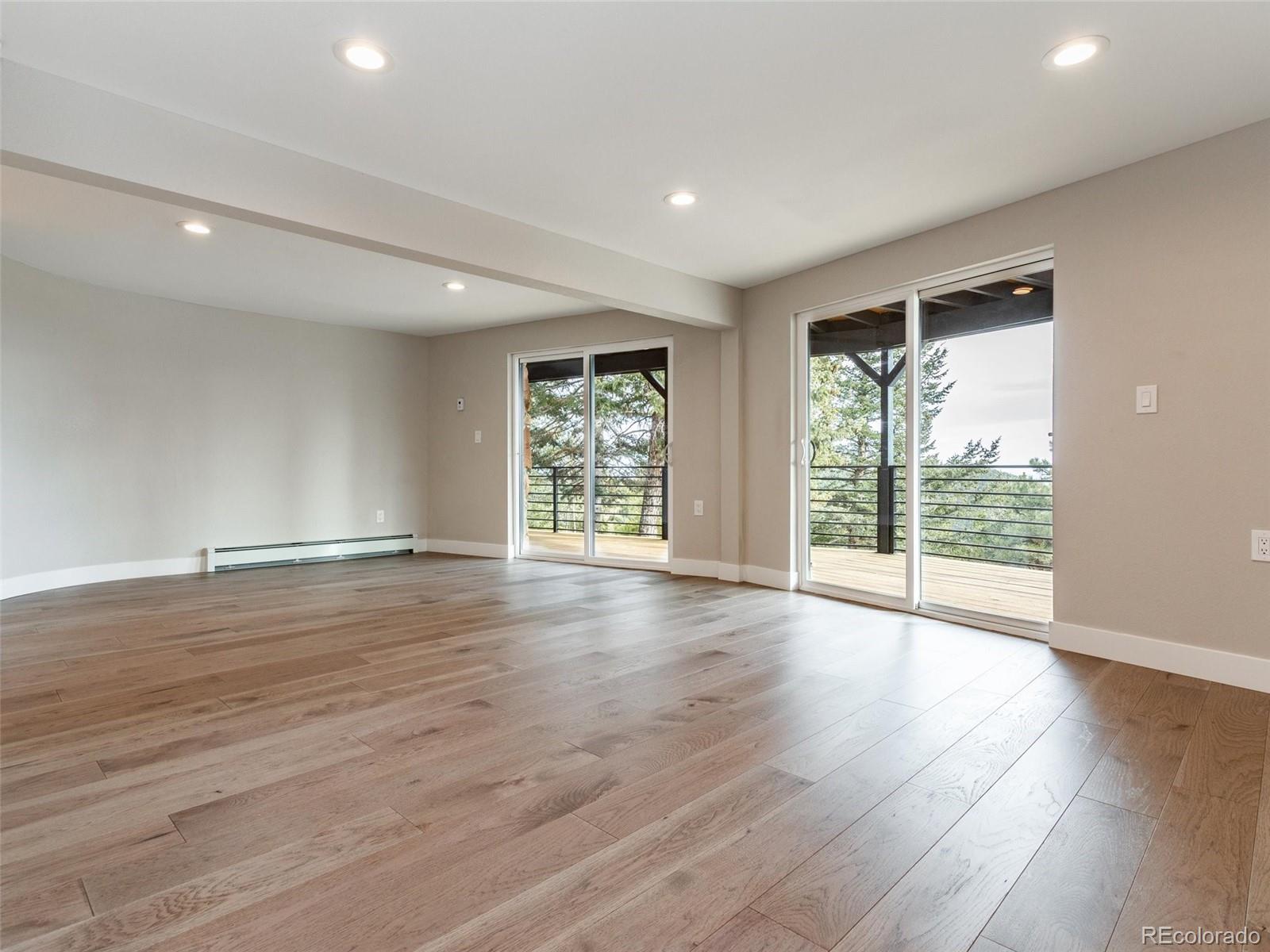 442 Deer Trail Road Boulder, CO 80302 - Photo 24 of 40 a view of an empty room with wooden floor and a window