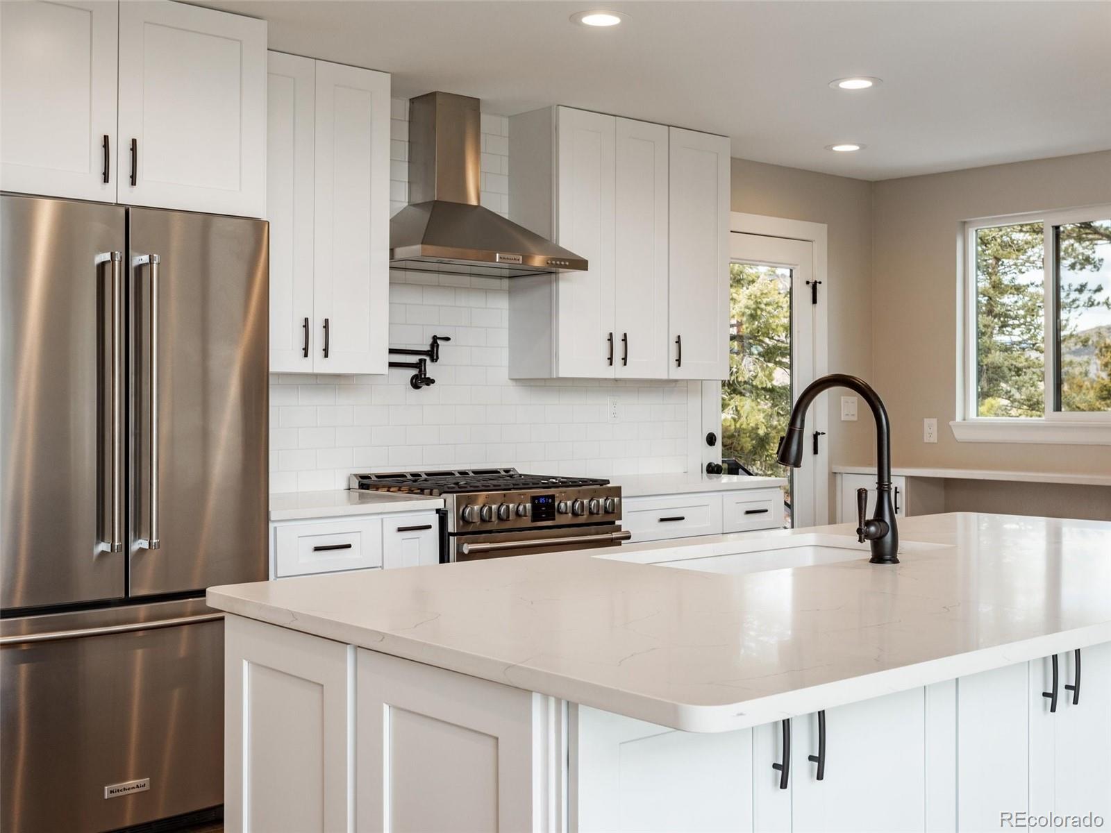 442 Deer Trail Road Boulder, CO 80302 - Photo 4 of 40 a kitchen with stainless steel appliances a sink a stove and a refrigerator