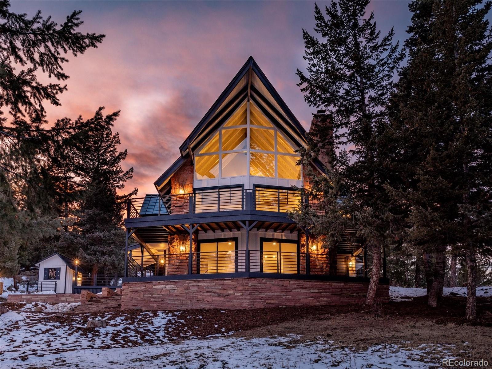 442 Deer Trail Road Boulder, CO 80302 - Photo 7 of 40 a view of a big house with large trees and a yard