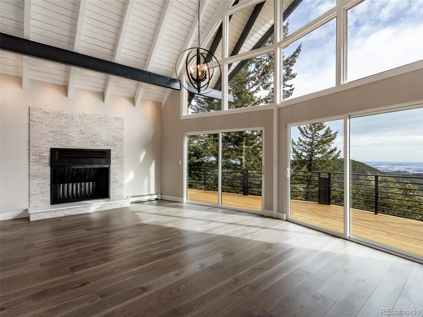 442 Deer Trail Road Boulder, CO 80302 - Photo 9 of 40 a view of an empty room with wooden floor and a window