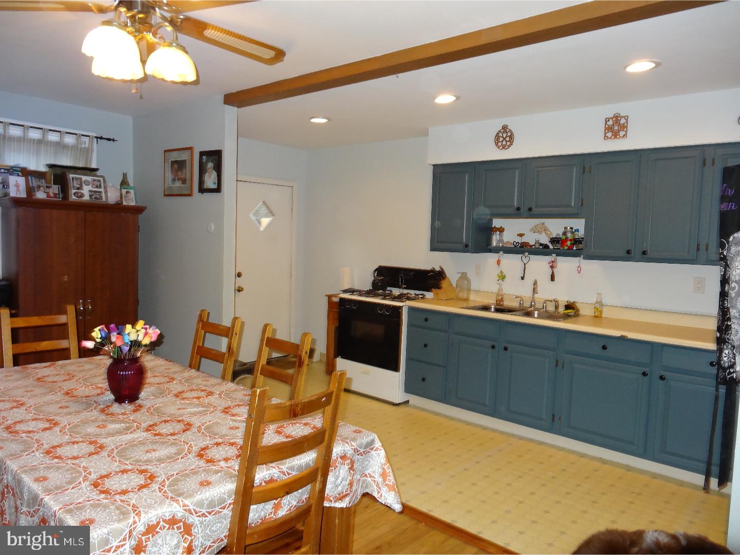 310 Ripka Street Philadelphia, PA 19128 - Photo 5 of 14 a kitchen with a sink a stove and chairs