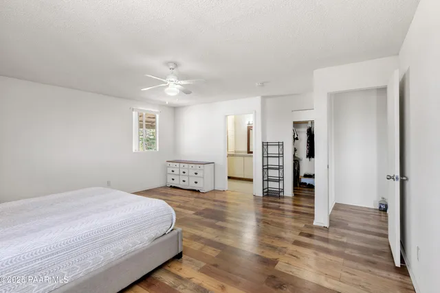 a spacious bedroom with a bed and a chandelier