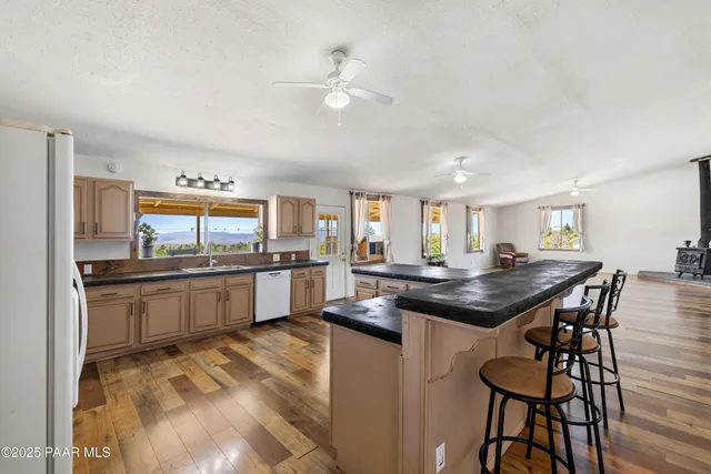 a kitchen with stainless steel appliances kitchen island granite countertop a sink and cabinets