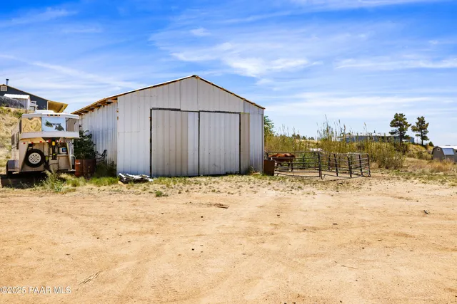 a view of a house with wooden fence
