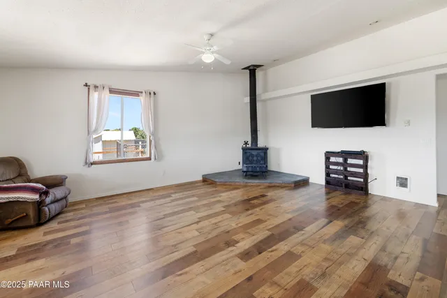a view of a livingroom with furniture and a flat screen tv