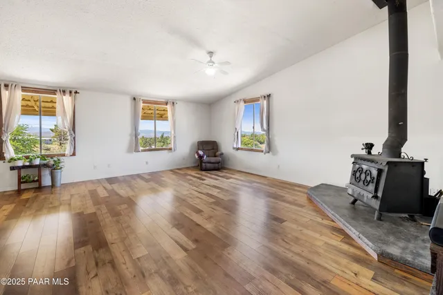 a view of a livingroom with wooden floor and a flat screen tv