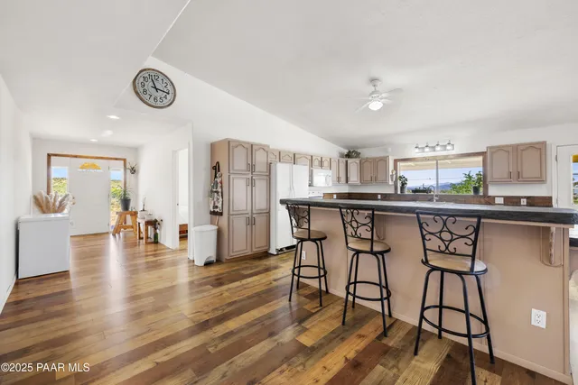 a kitchen with stainless steel appliances a dining table chairs and stove top oven