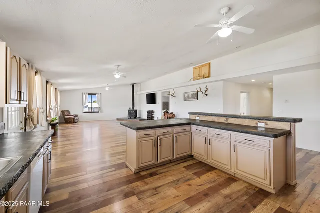 a large kitchen with a lot of counter space and a wooden floor
