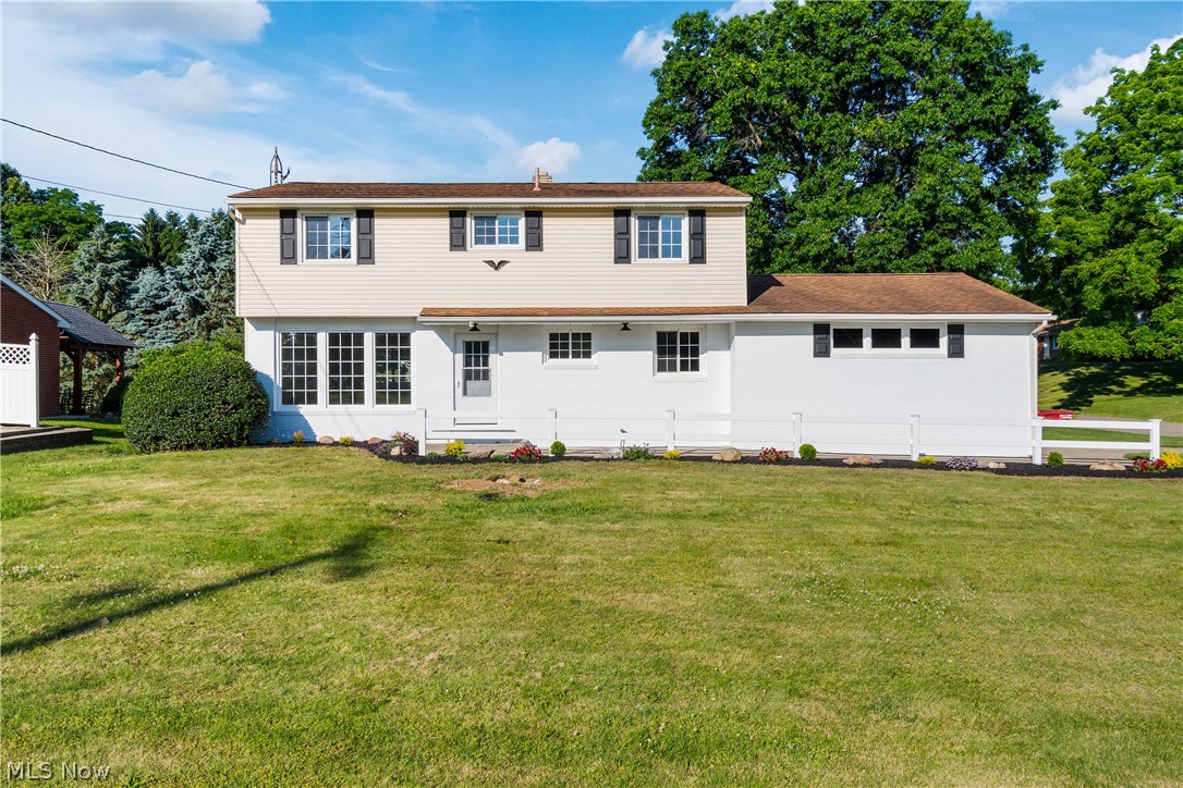 Back of house featuring a lawn