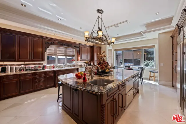 a view of a dining room and livingroom with furniture wooden floor a chandelier