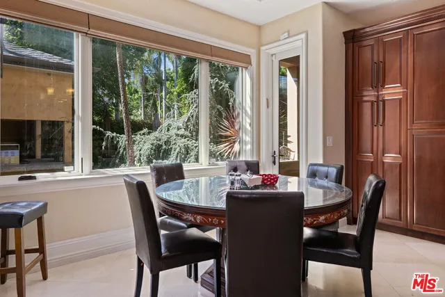 a dining table with chairs and window
