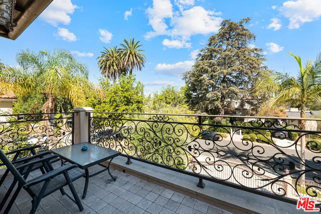 a bathroom with a granite countertop toilet sink and mirror