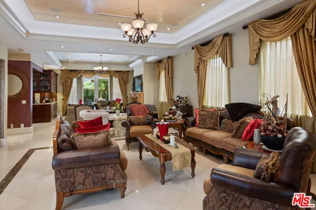 a living room with lots of furniture and a chandelier