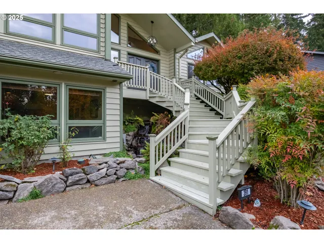 a view of a house with a small yard and potted plants