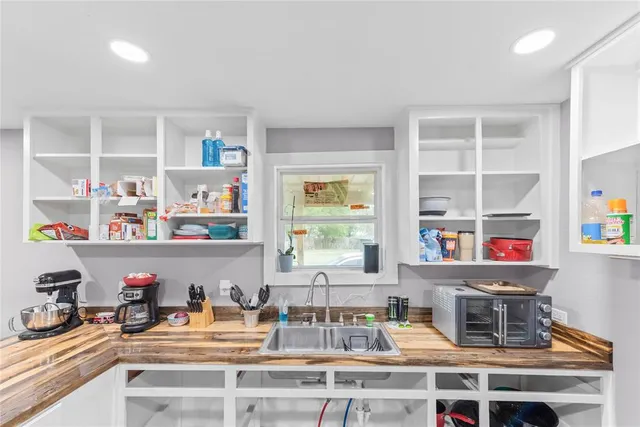a table with wine cabinets and a book shelf