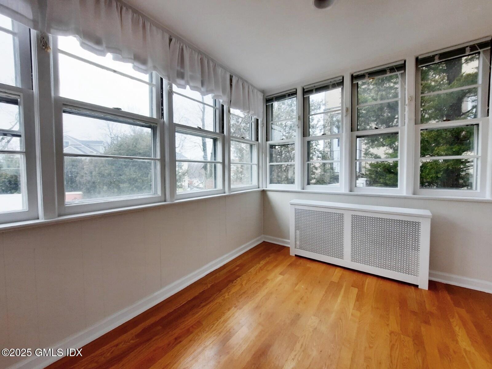 13 High Street Greenwich, CT 06830 - Photo 11 of 29 a view of an empty room with a window and wooden floor