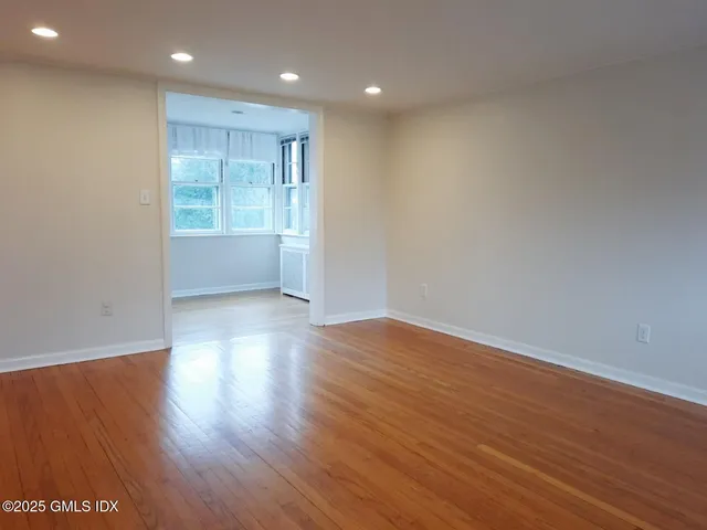 a bedroom with a bed and a dresser with mirror
