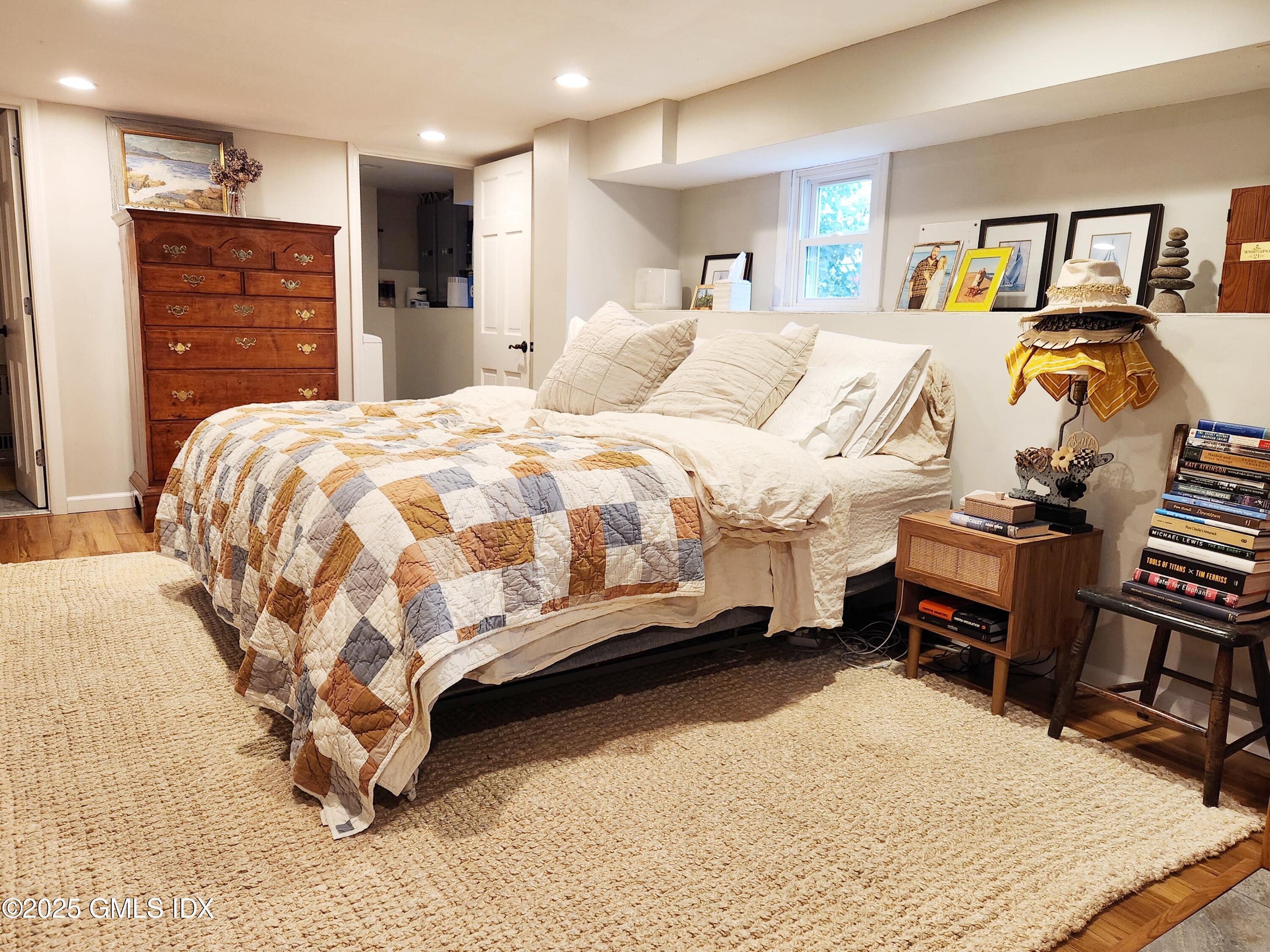 13 High Street Greenwich, CT 06830 - Photo 16 of 29 a bedroom with a bed and a dresser with mirror