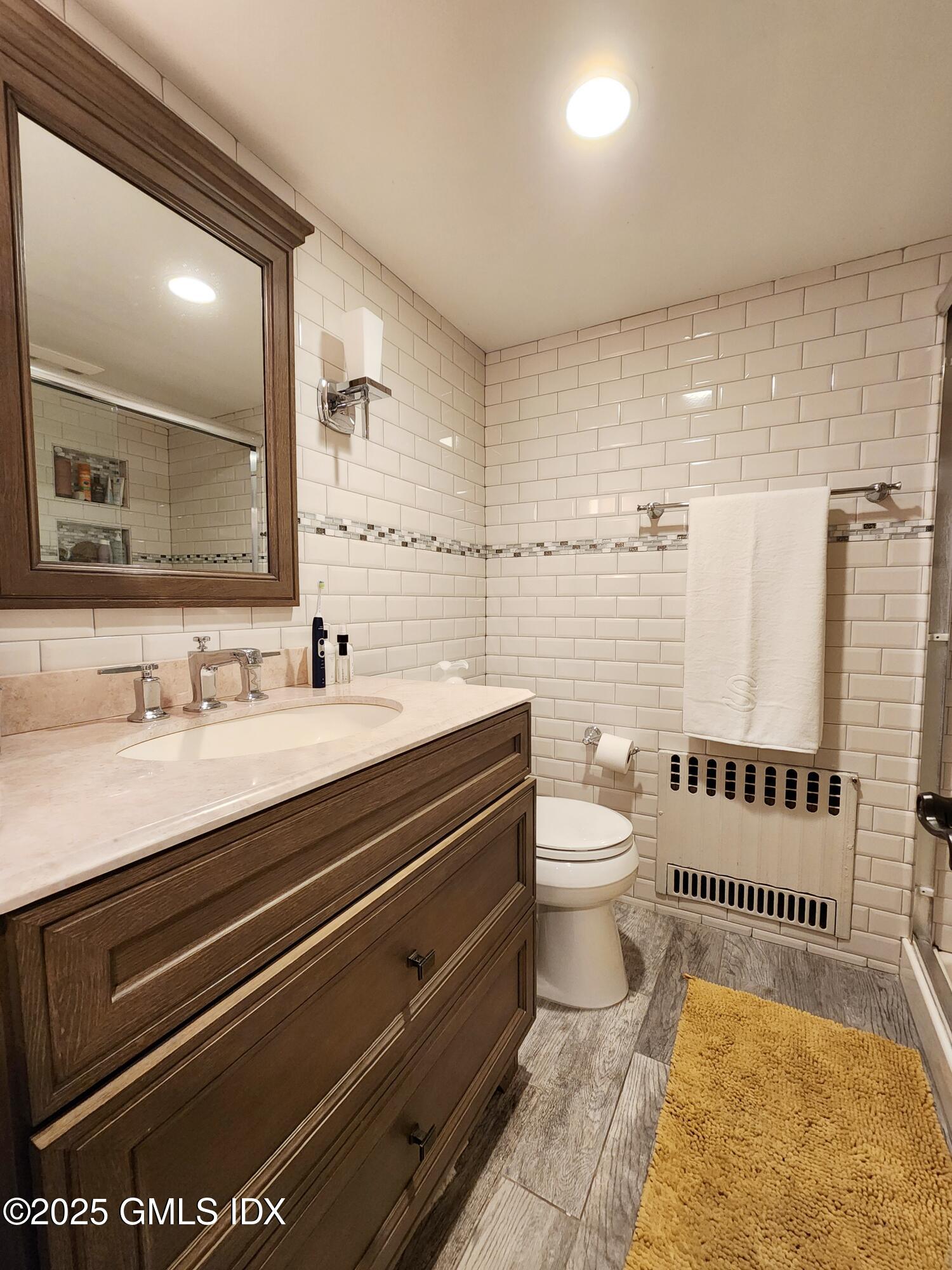 13 High Street Greenwich, CT 06830 - Photo 17 of 29 a bathroom with a sink a toilet and shower