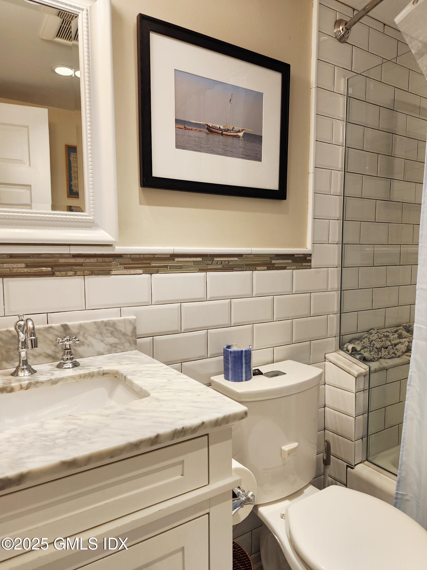 13 High Street Greenwich, CT 06830 - Photo 19 of 29 a bathroom with a toilet sink and mirror