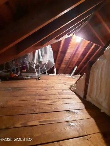 a view of an empty room and wooden floor