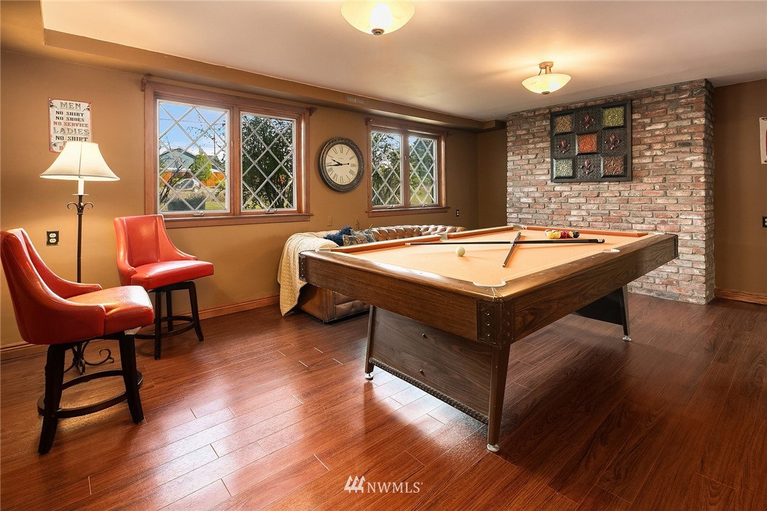 1714 Radio Road Ellensburg, WA 98926 - Photo 22 of 30 a room with wooden floor pool table and windows