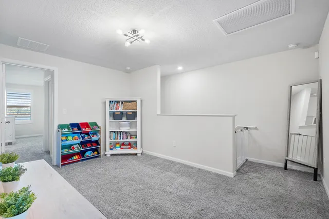 a living room with furniture and a book shelf