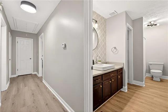 a spacious bathroom with a granite countertop sink toilet and shower