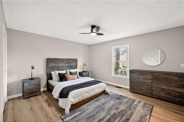 a bedroom with a large bed and a chandelier