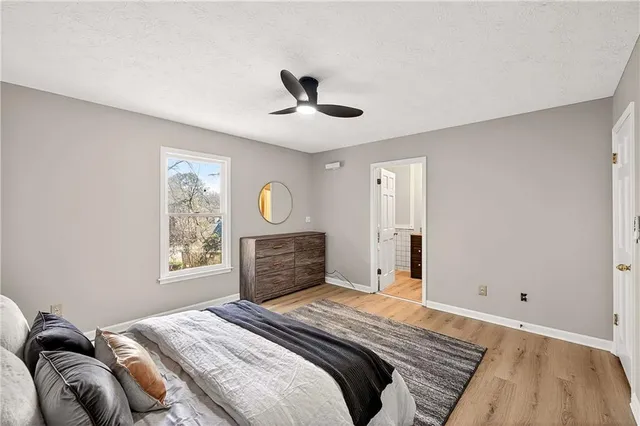 a bedroom with a large bed and a window