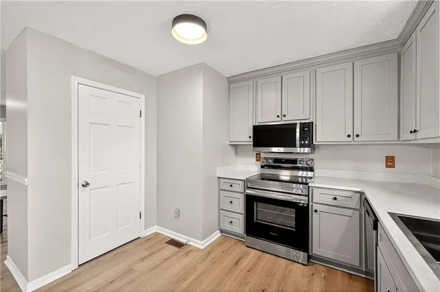 a kitchen with a stove and a microwave