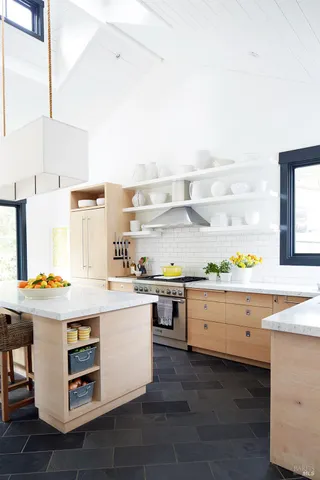 a kitchen with stainless steel appliances a stove and more cabinets
