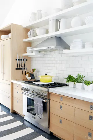 a kitchen with stainless steel appliances white cabinets and a stove