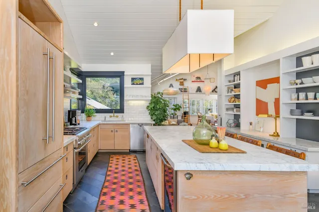 a kitchen with stainless steel appliances granite countertop a sink and stove