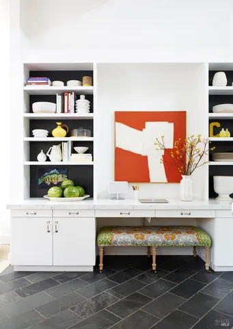 a view of a dining room with furniture and a potted plant