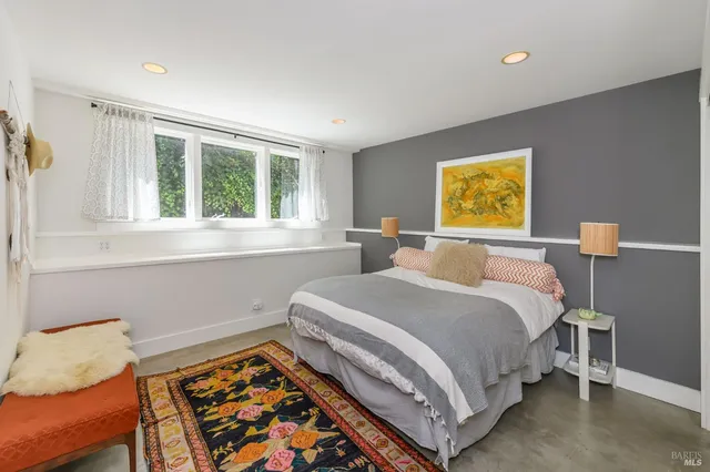 a living room with furniture and large windows