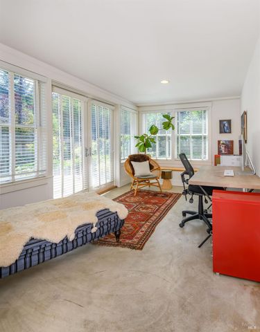 a living room with furniture and a floor to ceiling window