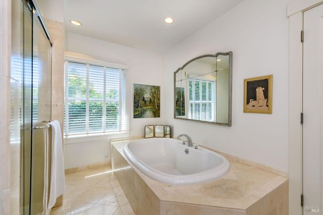 a bedroom with a bed and a flat screen tv on dresser