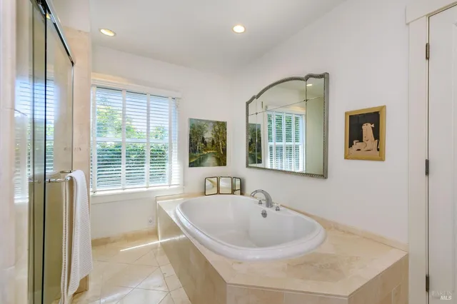 a bedroom with a bed and a flat screen tv on dresser