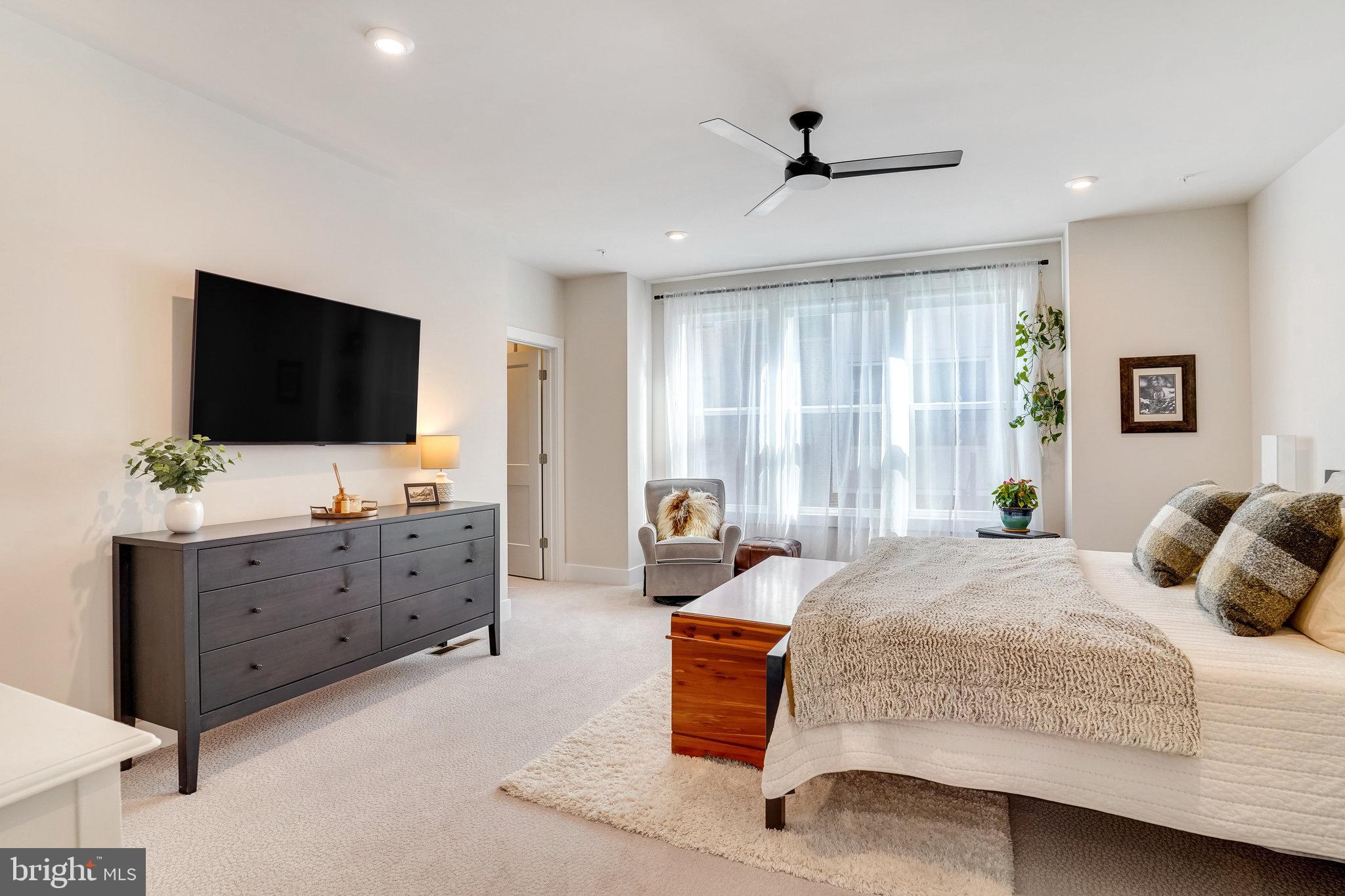1660 Bandit Loop Reston, VA 20190 - Photo 13 of 39 a bedroom with a bed and a flat screen tv