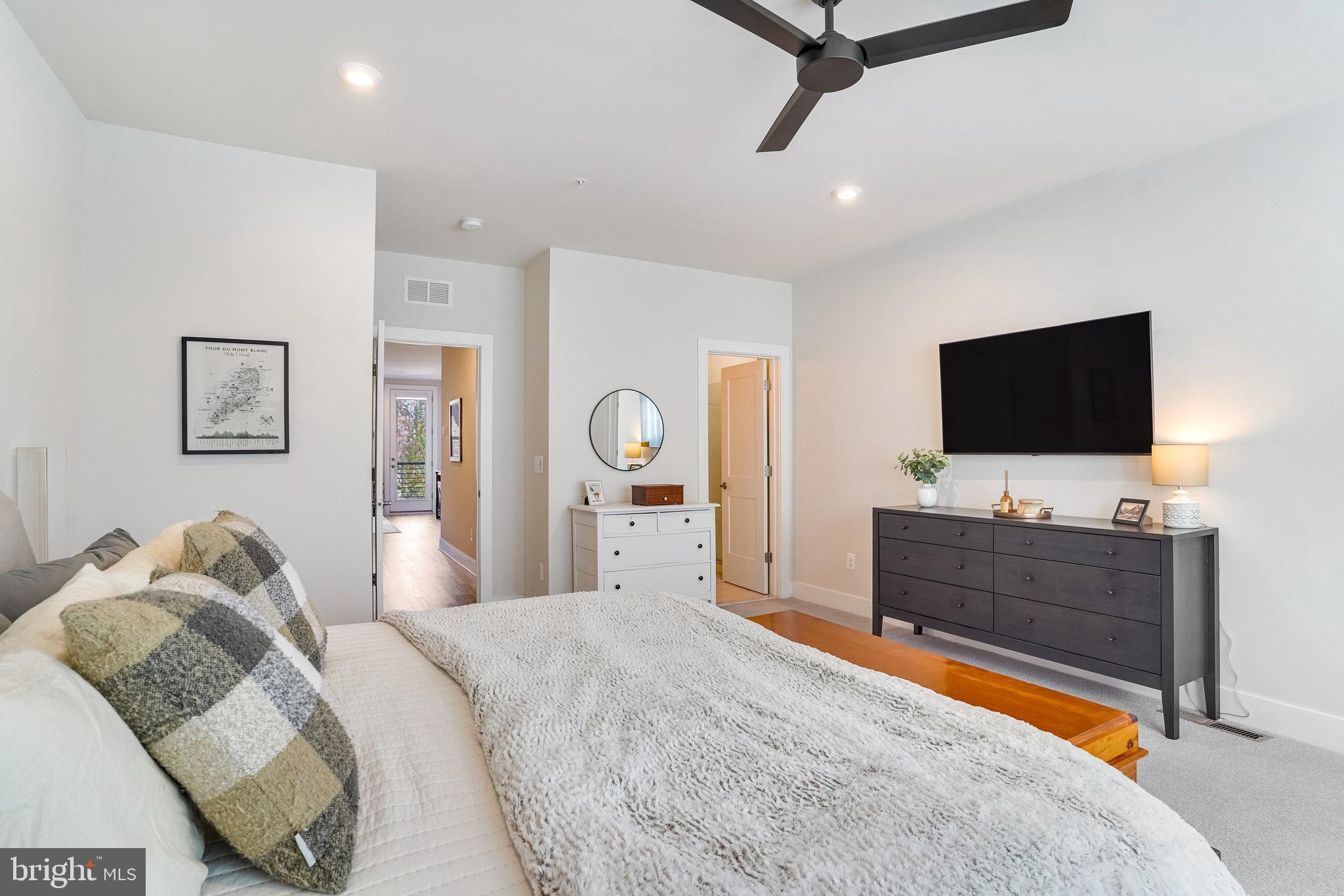 1660 Bandit Loop Reston, VA 20190 - Photo 15 of 39 a bedroom with a bed and a flat screen tv