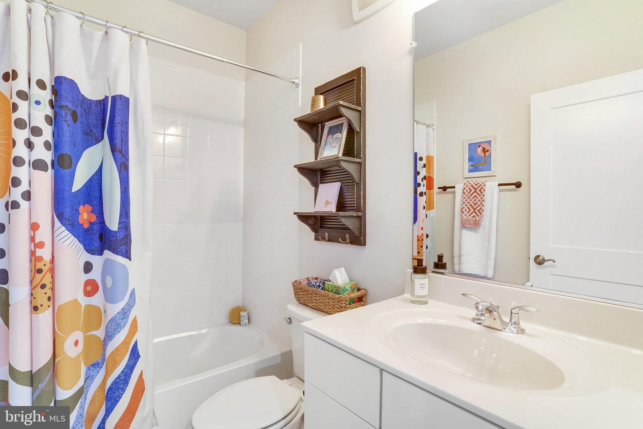 1660 Bandit Loop Reston, VA 20190 - Photo 21 of 39 a bathroom with a sink vanity mirror bathtub and shower