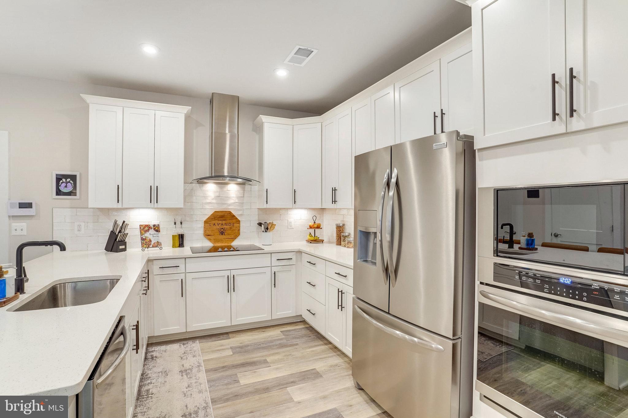 1660 Bandit Loop Reston, VA 20190 - Photo 8 of 39 a kitchen with granite countertop a refrigerator stove and sink