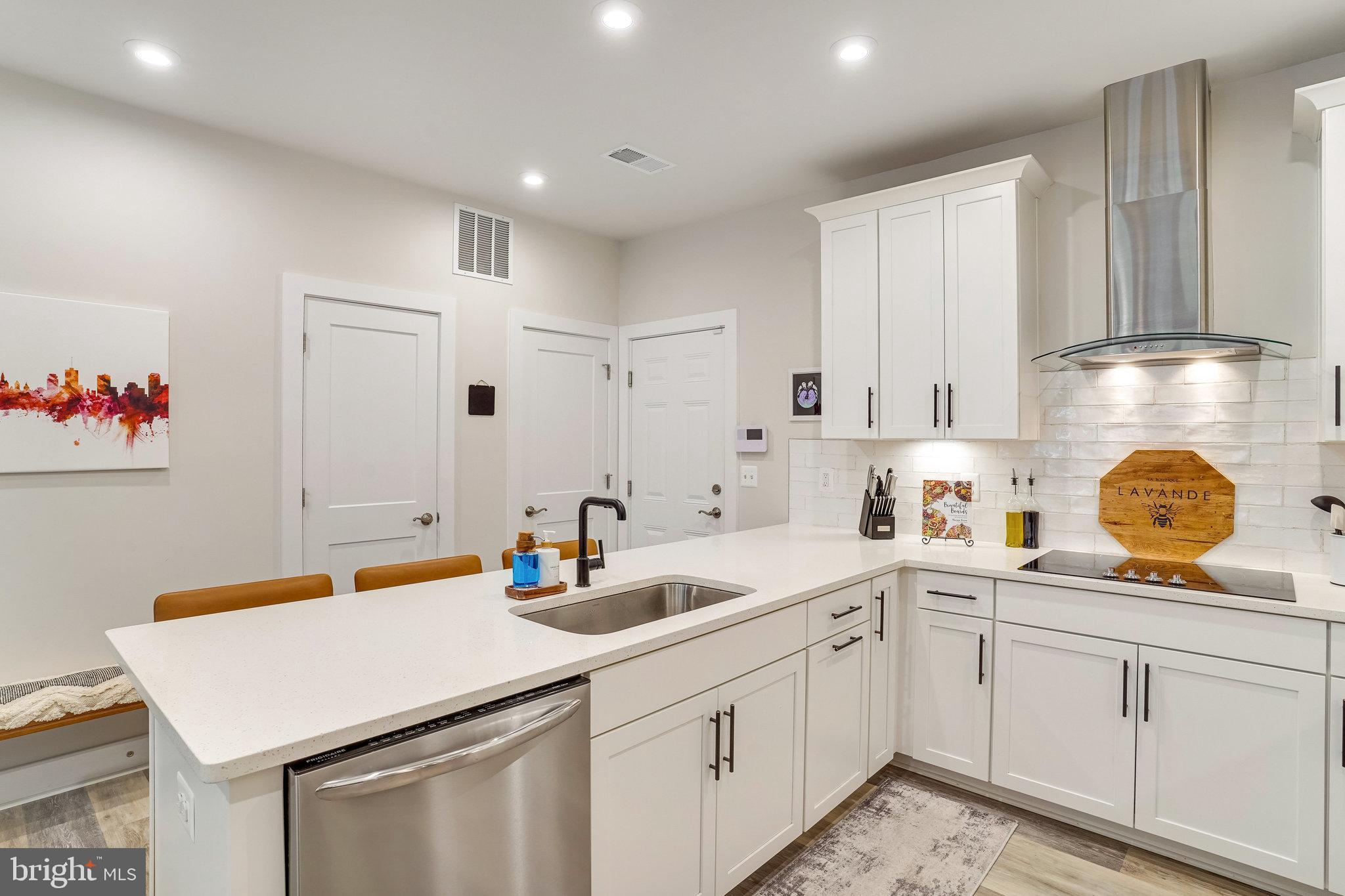 1660 Bandit Loop Reston, VA 20190 - Photo 10 of 39 a kitchen with a sink dishwasher and cabinets